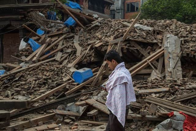 A survivor wanders through the rubble in Bhaktapur following the earthquake. Picture: Getty
