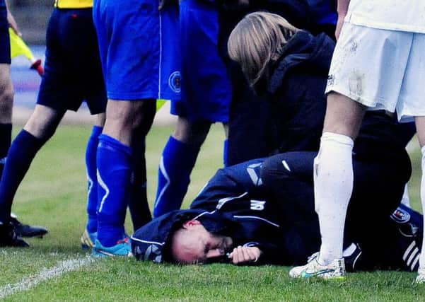 Bo'ness assistant manager Gary Wilcox is treated after the incident. Picture: Alan Murray