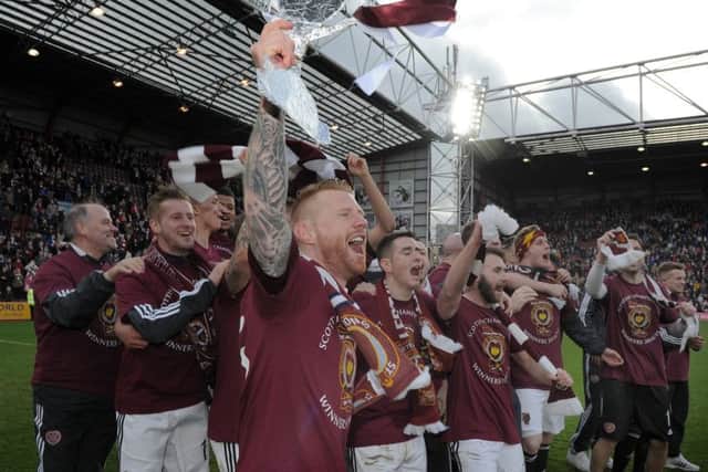 Hearts players celebrate after clinching the title against Queen of the South in March. Picture: Neil Hanna