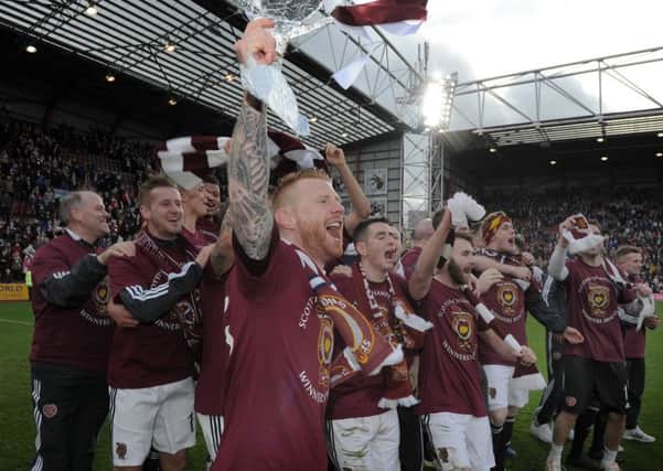 Hearts players celebrate after clinching the title against Queen of the South in March. Picture: Neil Hanna