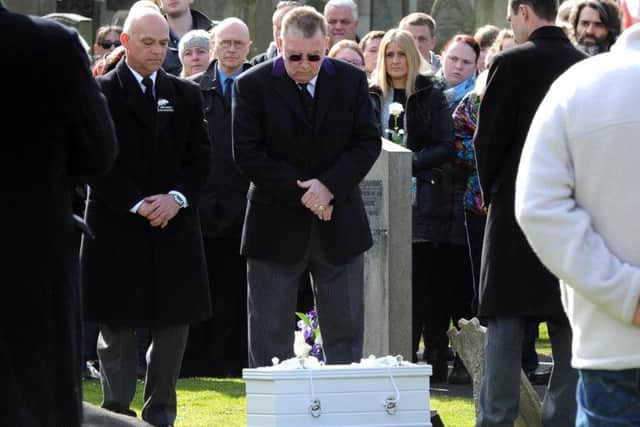 Mourners at Seafield Crematoriam pay their respects to a baby boy, who was laid to rest after being found on a path two years ago. Picture: Lisa Ferguson