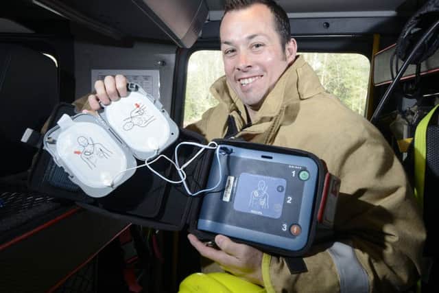 Dakeith Firefighter David Dickson with a Defibrillator carried in the fire engine. Pic: Julie Bull