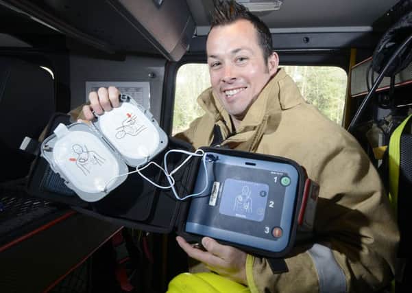 Dakeith Firefighter David Dickson with a Defibrillator carried in the fire engine. Pic: Julie Bull