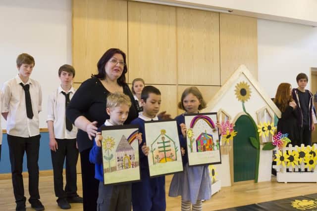 Janet Avery launches her ambitious project with some help from pupils at Victoria Primary and Trinity Academy who drew posters for the campaign