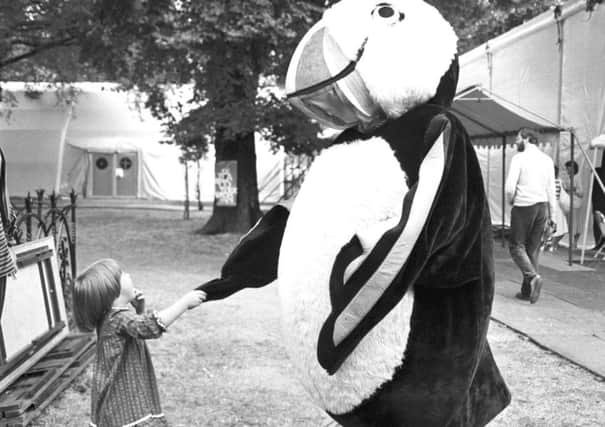 Three-year-old Catherine Blackwood meets a giant puffin at the Edinburgh Book Festival in Charlotte Square, August 1983.