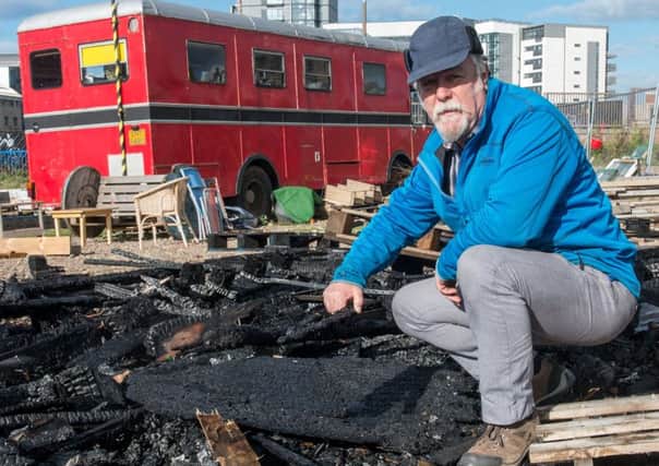 Stan Reeves with the charred remains of the greenhouse. Picture: Ian Georgeson