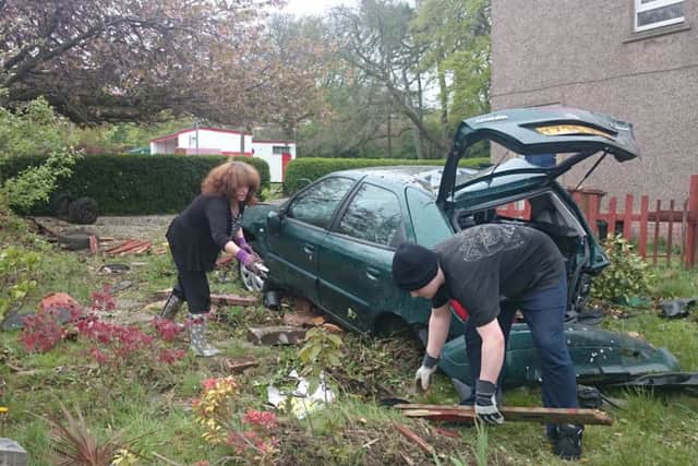 Residents begin the clear-up. Picture: Kaye Nicolson