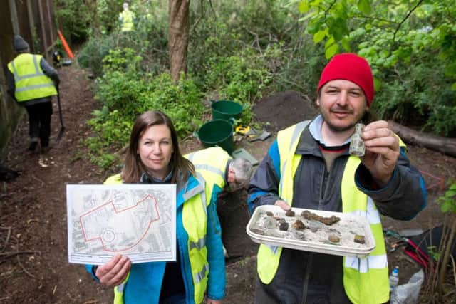 Cara Jones and Phil Richardson uncover objects. Picture: Alex Hewitt