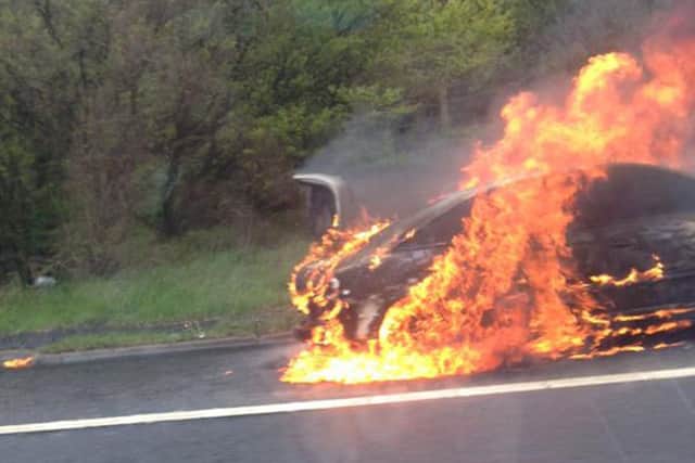 The flaming car on the M8 hard shoulder. Picture: Leann Kelly
