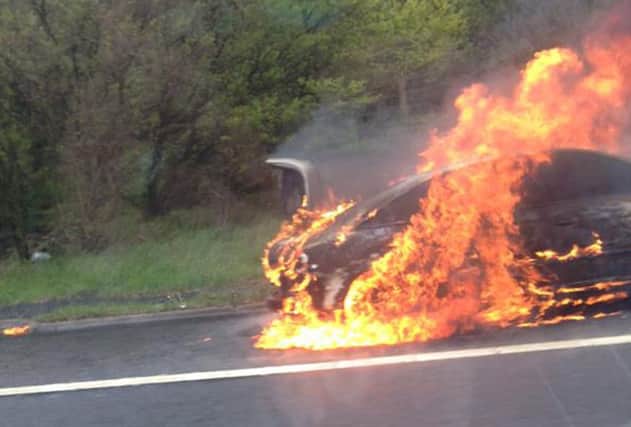 The flaming car on the M8 hard shoulder. Picture: Leann Kelly