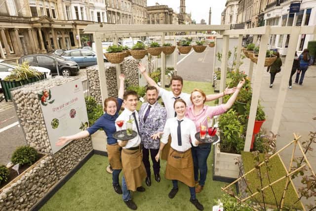 Parklets creator Craig Roman joins Jamie's Italian bar staff to serve drinks in a mini garden planted with cocktail ingredients. Picture: Malcolm McCurrach