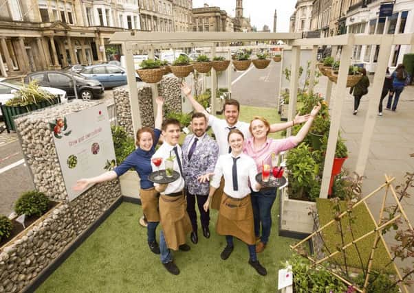 Parklets creator Craig Roman joins Jamie's Italian bar staff to serve drinks in a mini garden planted with cocktail ingredients. Picture: Malcolm McCurrach