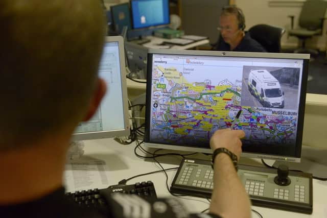 Using maps in the control room to pinpoint an incident location. Picture: Julie Bull