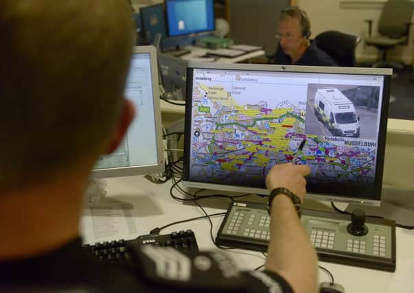 Using maps in the control room to pinpoint an incident location. Picture: Julie Bull