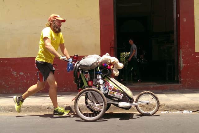 Jamie Ramsay pushes his belongings in a baby stroller. Picture: HeMedia