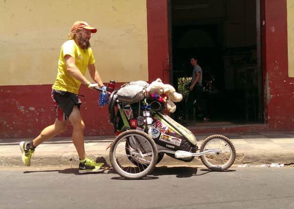 Jamie Ramsay pushes his belongings in a baby stroller. Picture: HeMedia
