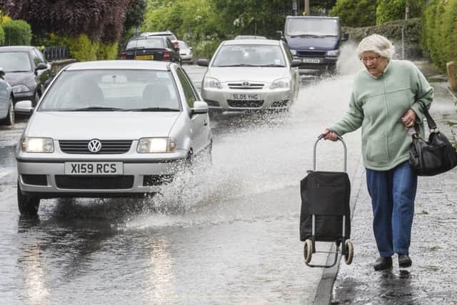 A car splashes through the flooded streets of Liberton. Picture: Scott Taylor