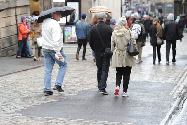 Unsightly tarmac has been placed on the cobbles at the top of the Royal Mile, much to the anger of traders. Picture: Neil Hanna
