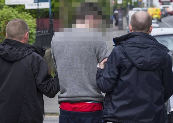 The suspect is led away by police officers