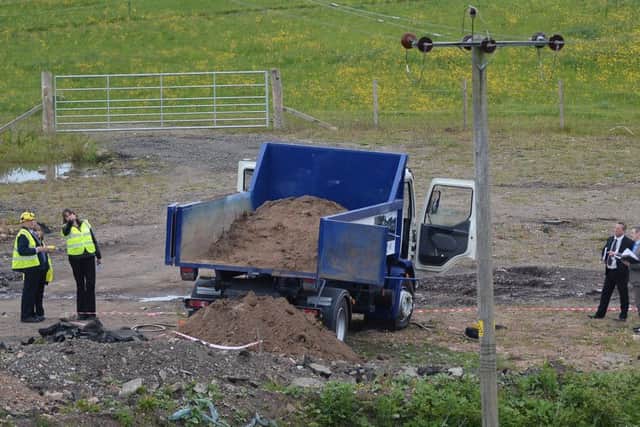 Officials and safety workers examine the scene of the tragedy at Kirknewton in West Lothian. Picture: Neil Hanna