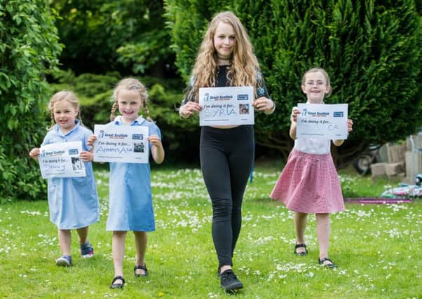 Tilly (4), Freya (6) and Ellis Imire (11) and Eva Watters (7) are ready to walk. Picture: Ian Georgeson