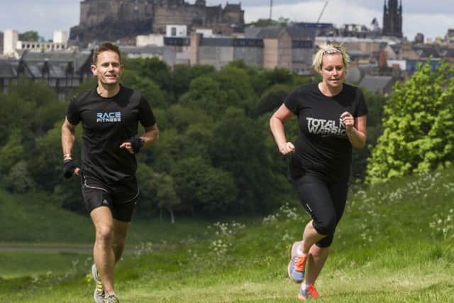 Kieron Ross puts Clare Smith through her paces on the slopes of Arthurs Seat as she prepares for three months of training ahead of the Total Warrior event in North Berwick. Picture: Scott Taylor