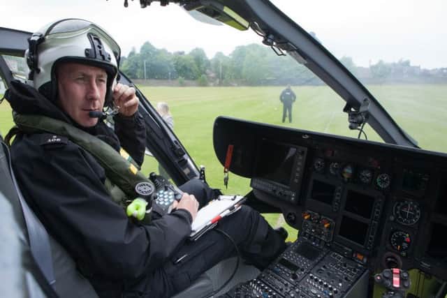 Constable David McCaig on board the helicopter. Picture: Toby Williams