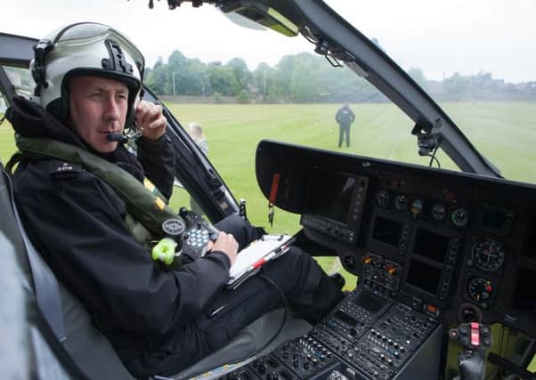 Constable David McCaig on board the helicopter. Picture: Toby Williams