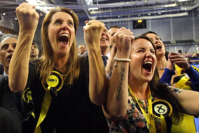 Jubilant SNP supporters celebrate on election night last month