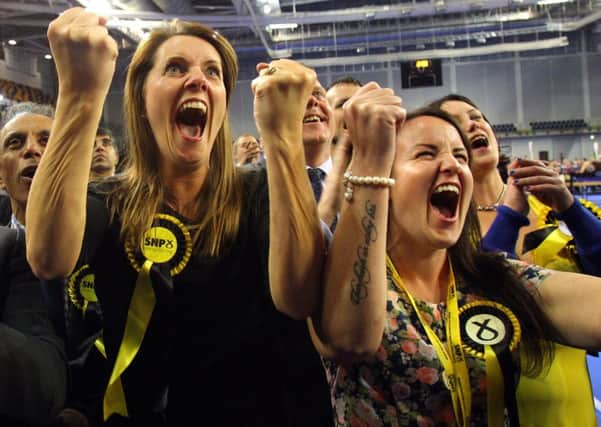 Jubilant SNP supporters celebrate on election night last month