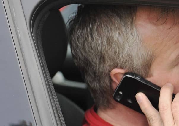 Using your mobile phone while driving is illegal. Picture: Phil Wilkinson (Posed by model)