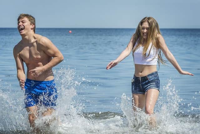 Ryan Steadwood and Natasha Hill cool off at Portobello beach. Picture: Scott Taylor