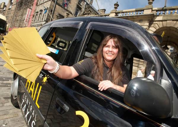 Taxi driver 
Mandy Forrest hands out her golden tickets. Picture: Rob McDougall