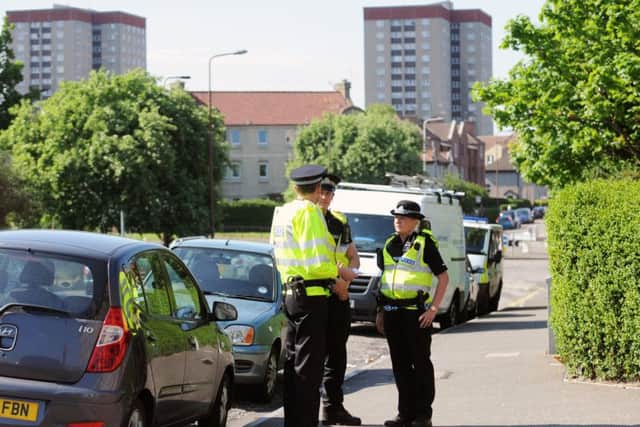Police officers patrol along Restalrig Road South in the Lochend area of Edinburgh. Picture: TSPL