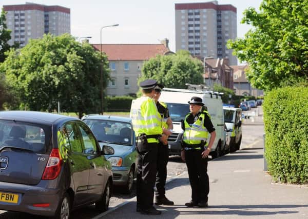 Police officers patrol along Restalrig Road South in the Lochend area of Edinburgh. Picture: TSPL