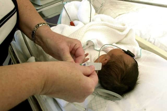 A baby receives treatment at St John's. Picture: Bill Henry