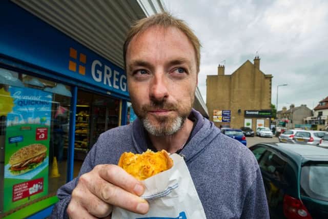 Jason Keddie enjoys a Greggs macarroni pie from the Corstorphine Shop while he still can. Picture: Scott Taylor
