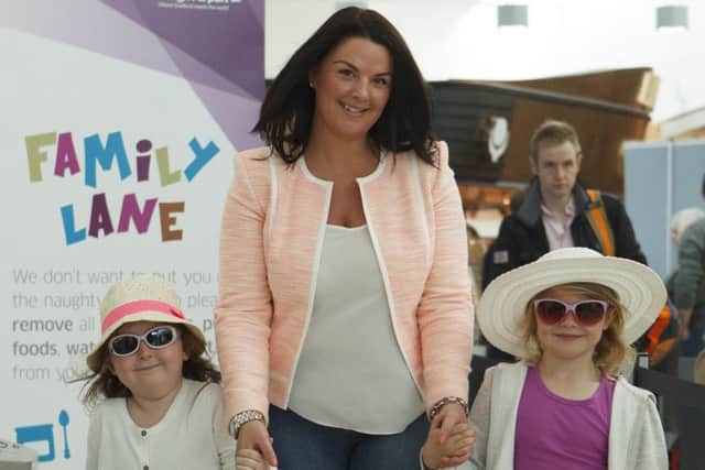 Charlene Wilson with Taylor Crozier, left, and Eva Wilson, flying to Spain. Picture: Toby Williams