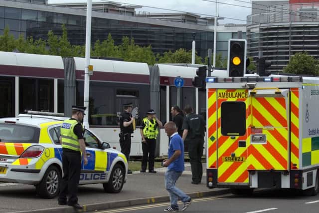 Police take statements after the man was hit by a tram near the Gyle at around 2pm yesterday. Picture: ALAN SIMPSON