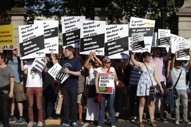 Pro-Choice supporters hold placards in front of the gates of the Irish Parliament building in Dublin on July 10, 2013 during a demonstration ahead of a vote to introduce abortion in limited cases where the mother's life is at risk. The bill follows a 2010 European Court of Human Rights ruling that found Ireland failed to implement properly the constitutional right to abortion where a woman's life is at risk.                    AFP PHOTO / PETER MUHLY        (Photo credit should read PETER MUHLY/AFP/Getty Images)