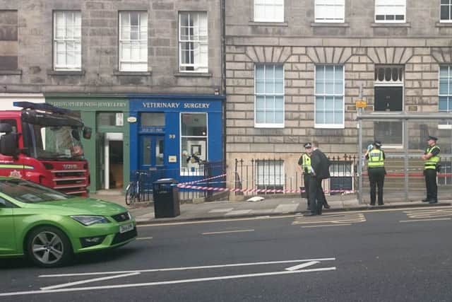 Police and firefighters at the scene as a piece of the railing had to be removed. Picture: Kaye Nicolson