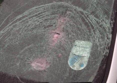 The cracked windscreen which was smashed by a bottle thrown from an overpass.
