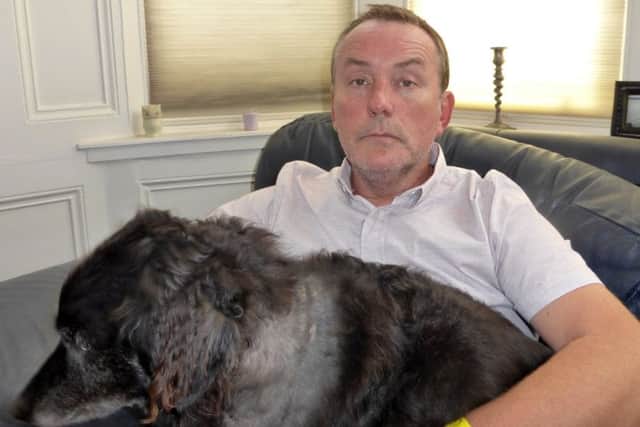Gary Wilson with his injured dog Boomette. Picture: comp