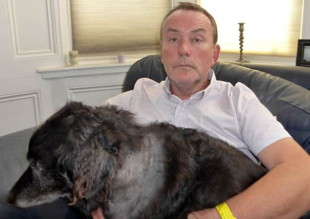 Gary Wilson with his injured dog Boomette. Picture: comp