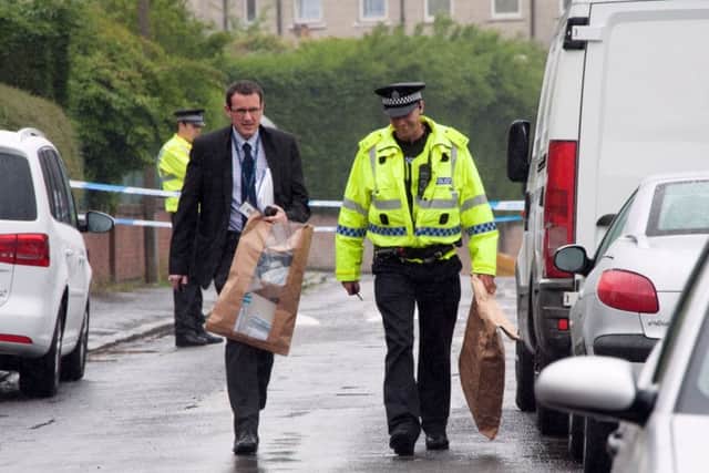 Police remove evidence bags from the scene after a thorough search. Picture: Andrew O'Brien