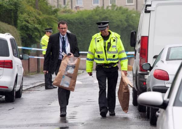 Police remove evidence bags from the scene after a thorough search. Picture: Andrew O'Brien