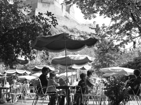 People enjoying the summer sunshine at The Piazza open-air cafe in Princes Street Gardens Edinburgh in August 1970