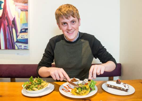 News reporter Alistair Grant tucks in to Henderson's vegan menu. Picture: Ian Georgeson