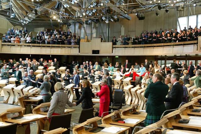 MSPs stand in Parliament. A register for lobbyists could prevent businesses from debating policy, the FSB has warned. Picture: TSPL
