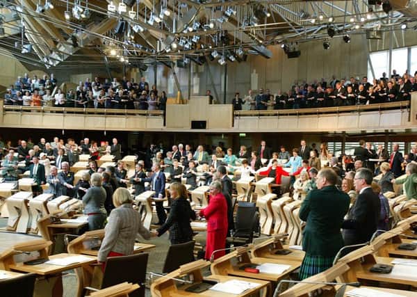 MSPs stand in Parliament. A register for lobbyists could prevent businesses from debating policy, the FSB has warned. Picture: TSPL